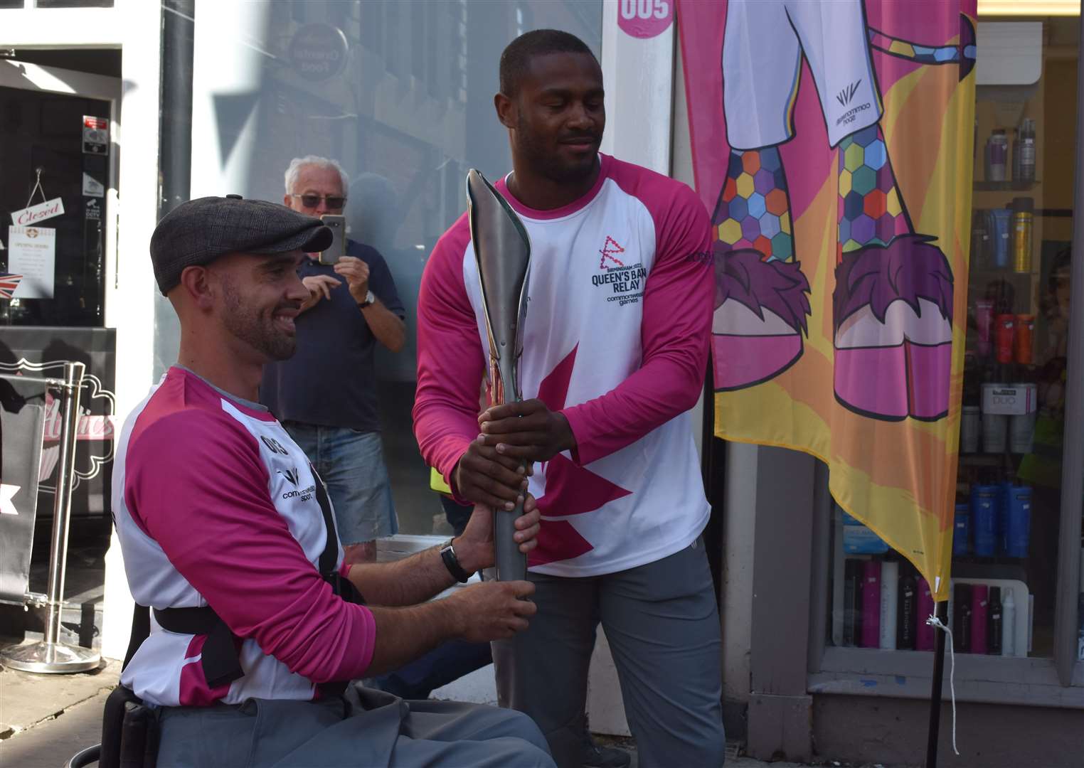 Paralympian John Boy Smith passes the baton to recently turned pro boxer Cheavon Clarke. Picture: Jason Arthur