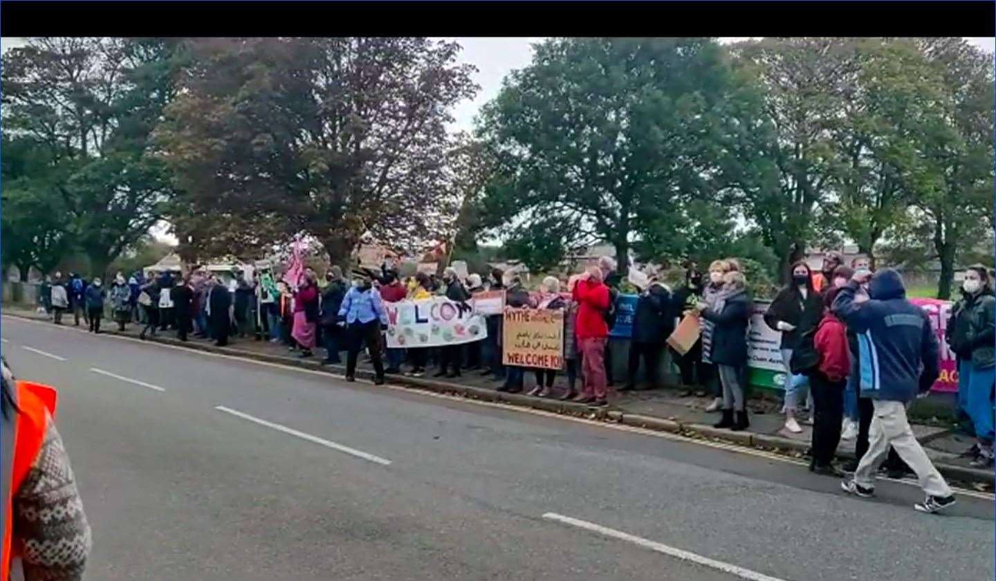 Supporters wave at asylum seekers