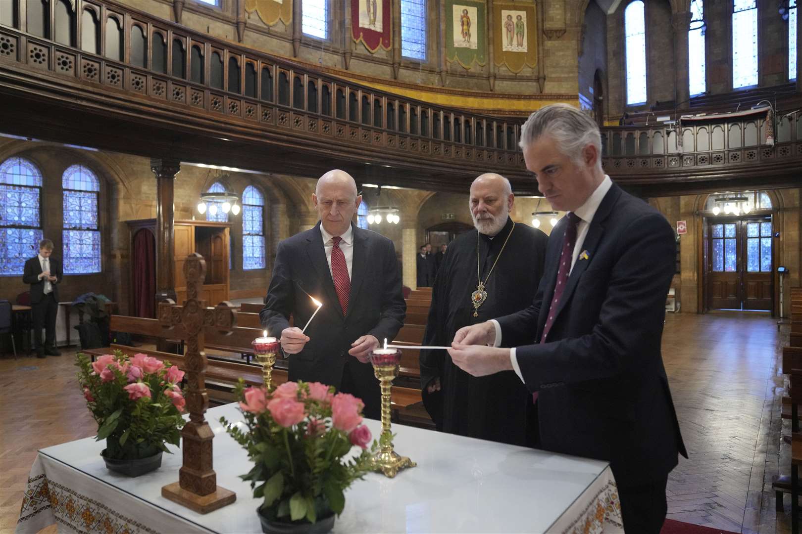 Defence Secretary John Healey, Bishop of Ukraine Diocese Kenneth Nowakoski and shadow secretary of defence James Cartlidge light candles (Kin Cheung/PA)