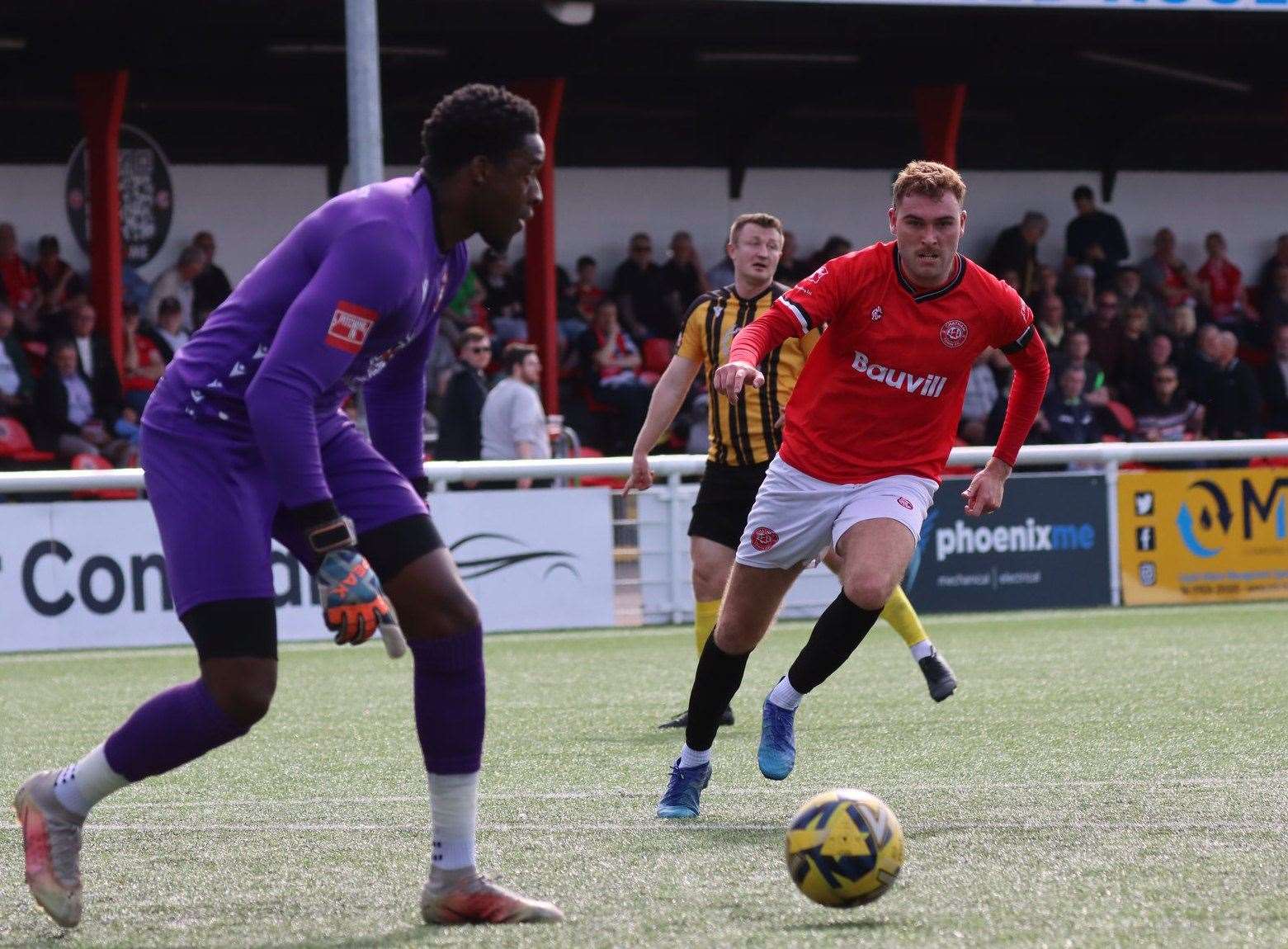 Chatham goalscorer Harvey Bradbury closes down Folkestone keeper Kai McKenzie-Lyle. Picture: Max English (@max_ePhotos)