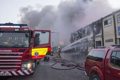 The flames spread to a building late into the afternoon