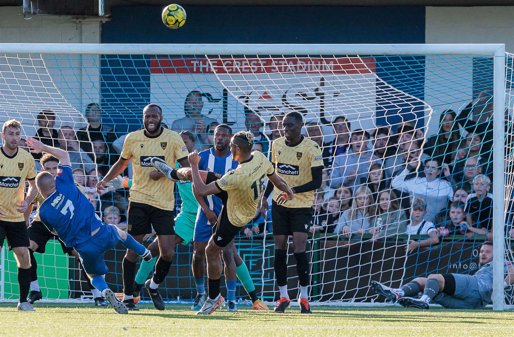 Maidstone substitute Matt Bentley cannons an attempted clearance against Herne Bay's Scott Heard and the ball goes over for a goal kick - while Herne Bay keeper Harry Brooks watches on from the Maidstone net! Picture: Helen Cooper