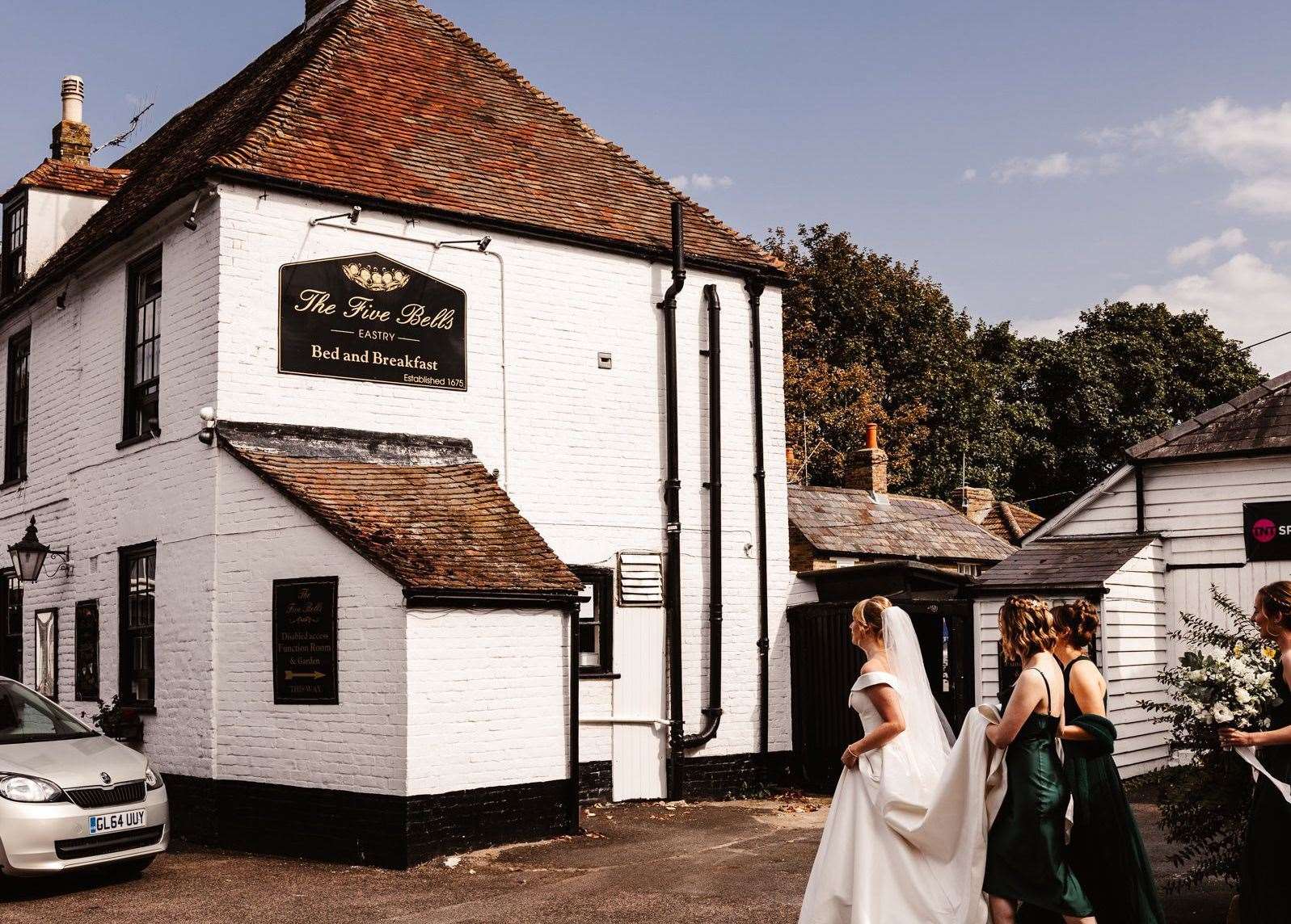 Jeanette Smith on her wedding day walking towards the Five Bells at Eastry. It still has the sign she designed as child. Picture: Olly Knight