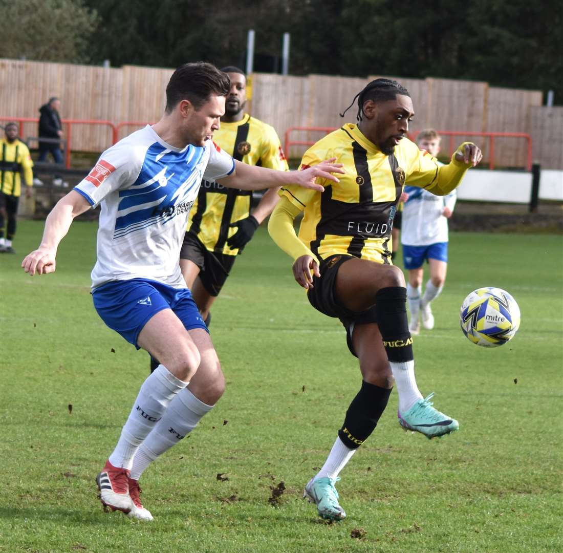 Herne Bay forward Gil Carvalho, right, shields the ball at Erith & Belvedere Picture: Alan Coomes