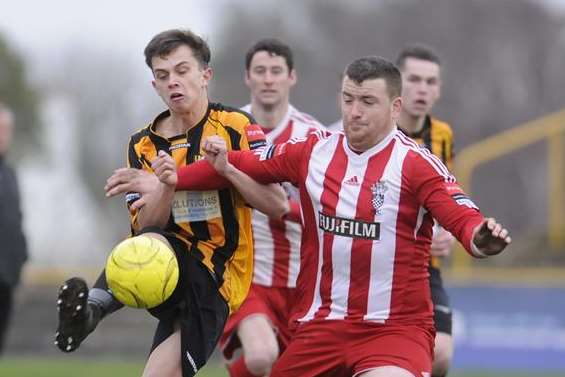 Folkestone Invicta's Johan Ter Horst (amber and black) tries to make headway against Redhill during Saturday's 3-1 Ryman League Division 1 South win