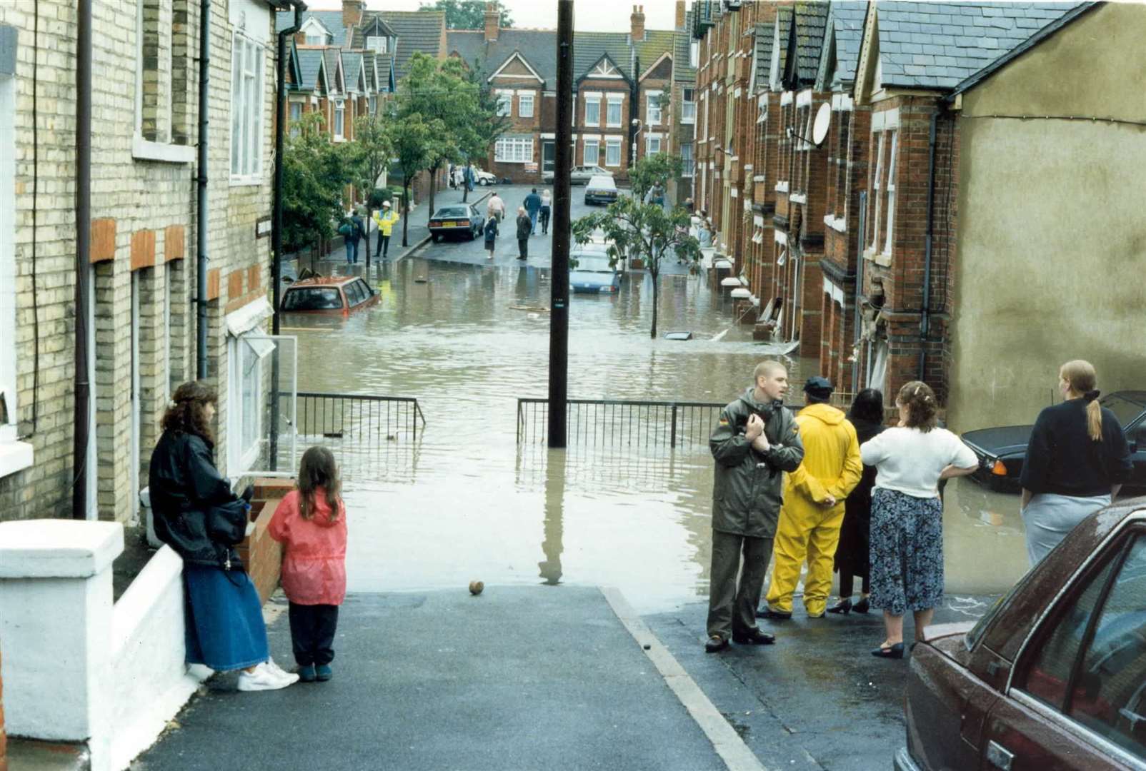 Onlookers at the edge of flood waters in Folkestone in 1996