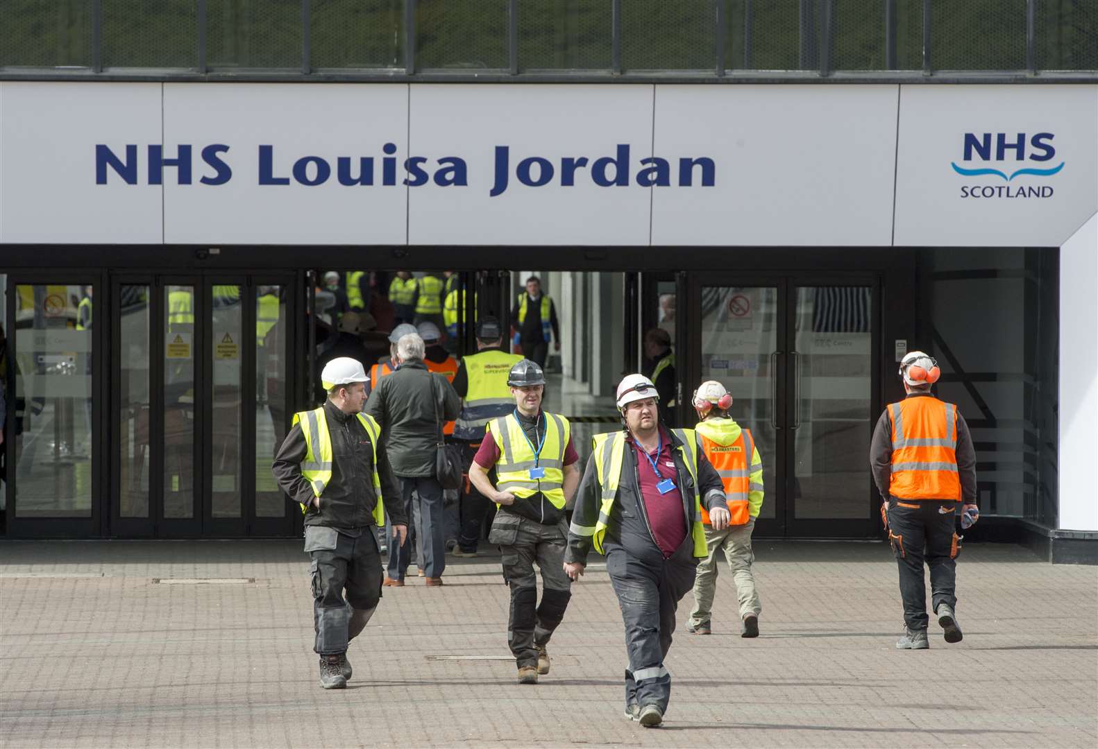 Workers outside the new temporary NHS Louisa Jordan Hospital at the SEC event centre, Glasgow (Ian Rutherford/PA)