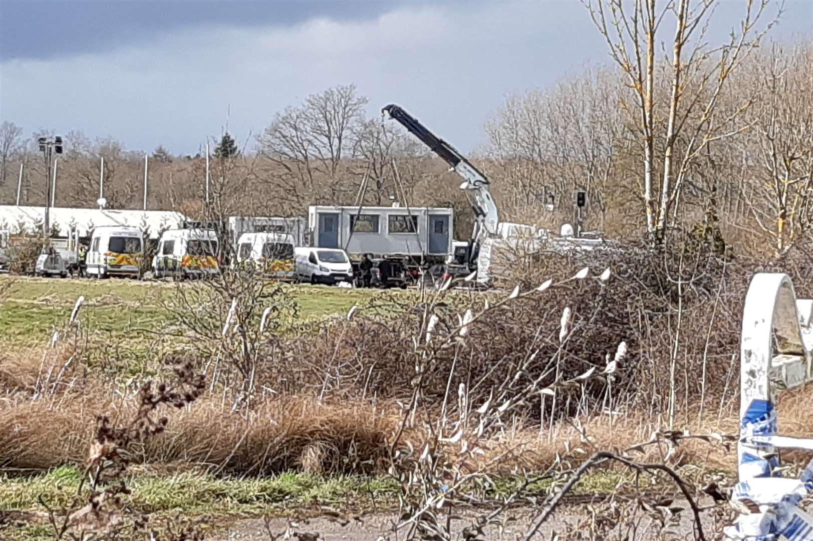 One of the temporary welfare units is lifted into place on Thursday afternoon