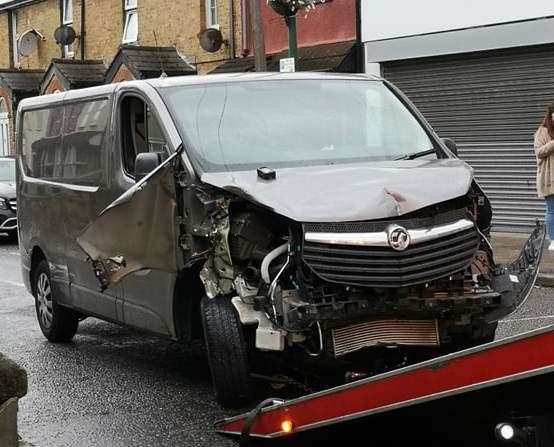 The damaged vehicle being seized by police