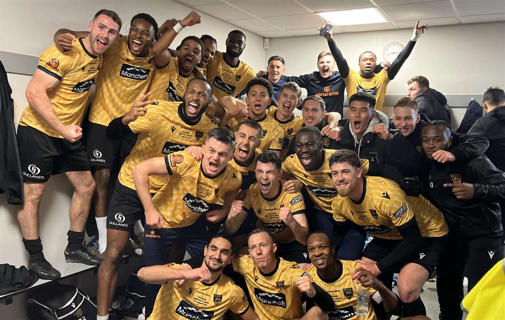 Maidstone United players celebrate in the dressing room after beating Stevenage. Picture: Steve Terrell