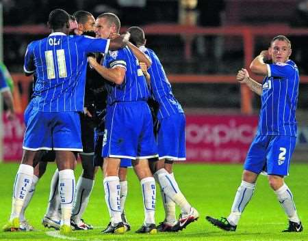 Gills players mob Jack Payne after the midfielder restored their lead with around 15 minutes remaining.