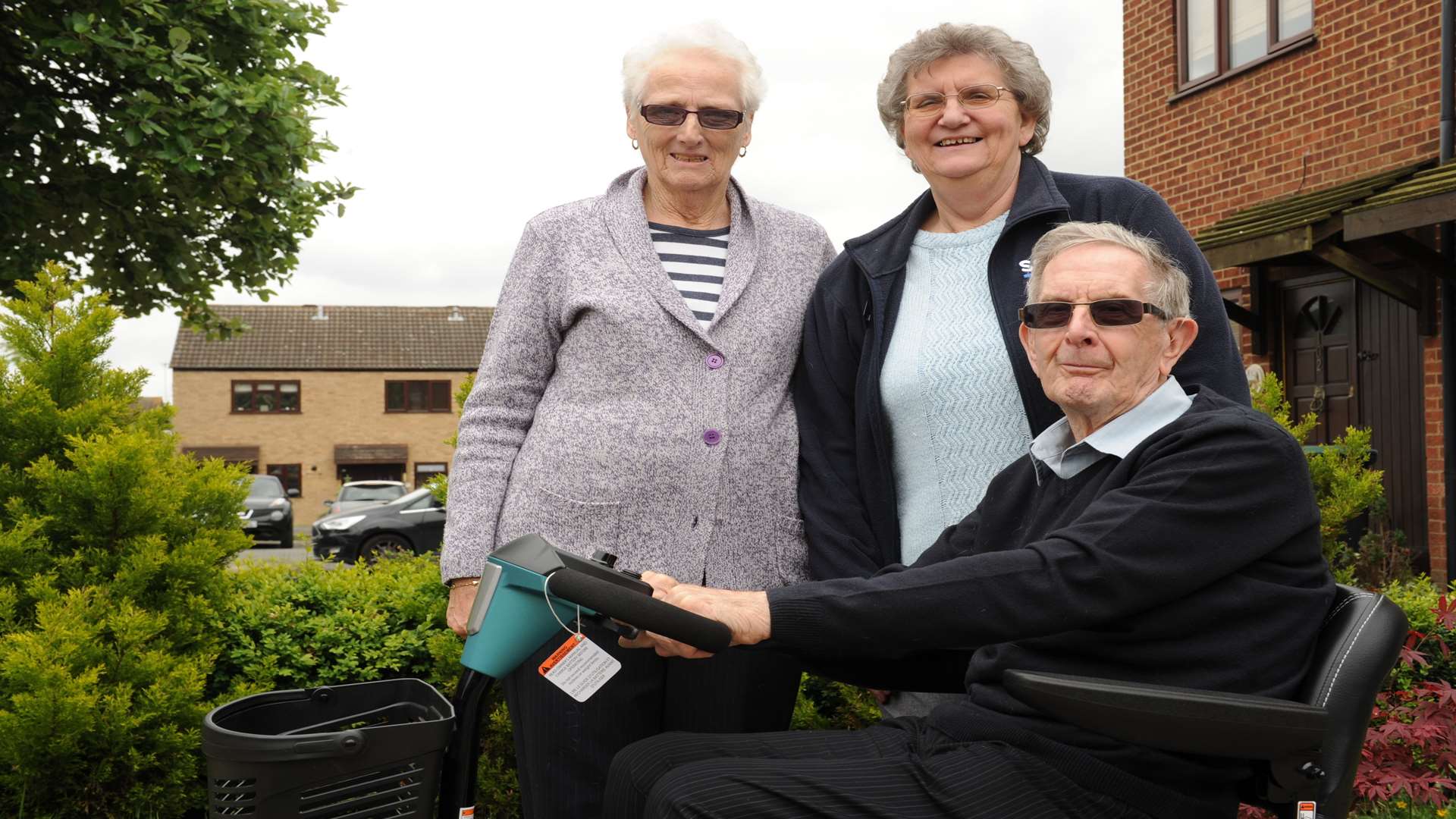 Kenneth Godbold with his new mobility scooter, and wife Mavis (left) and Mary Walker from SSAFA (right)