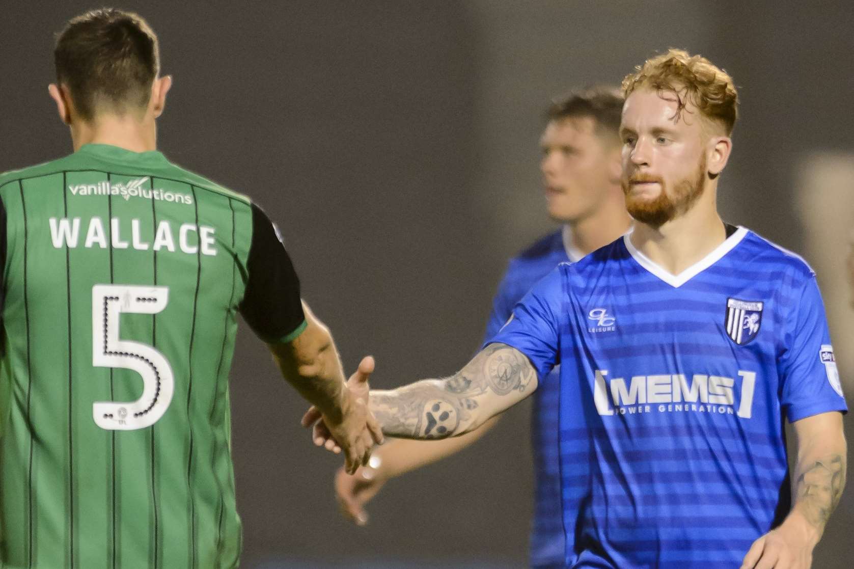 Connor Ogilvie and Scunthorpe's Murray Wallace shake hands Picture: Andy Payton