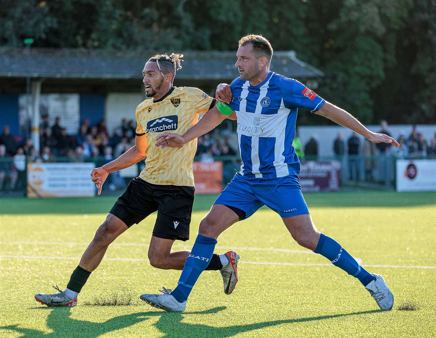 Herne Bay captain Liam Friend holds off Maidstone's Matt Bentley. Picture: Helen Cooper