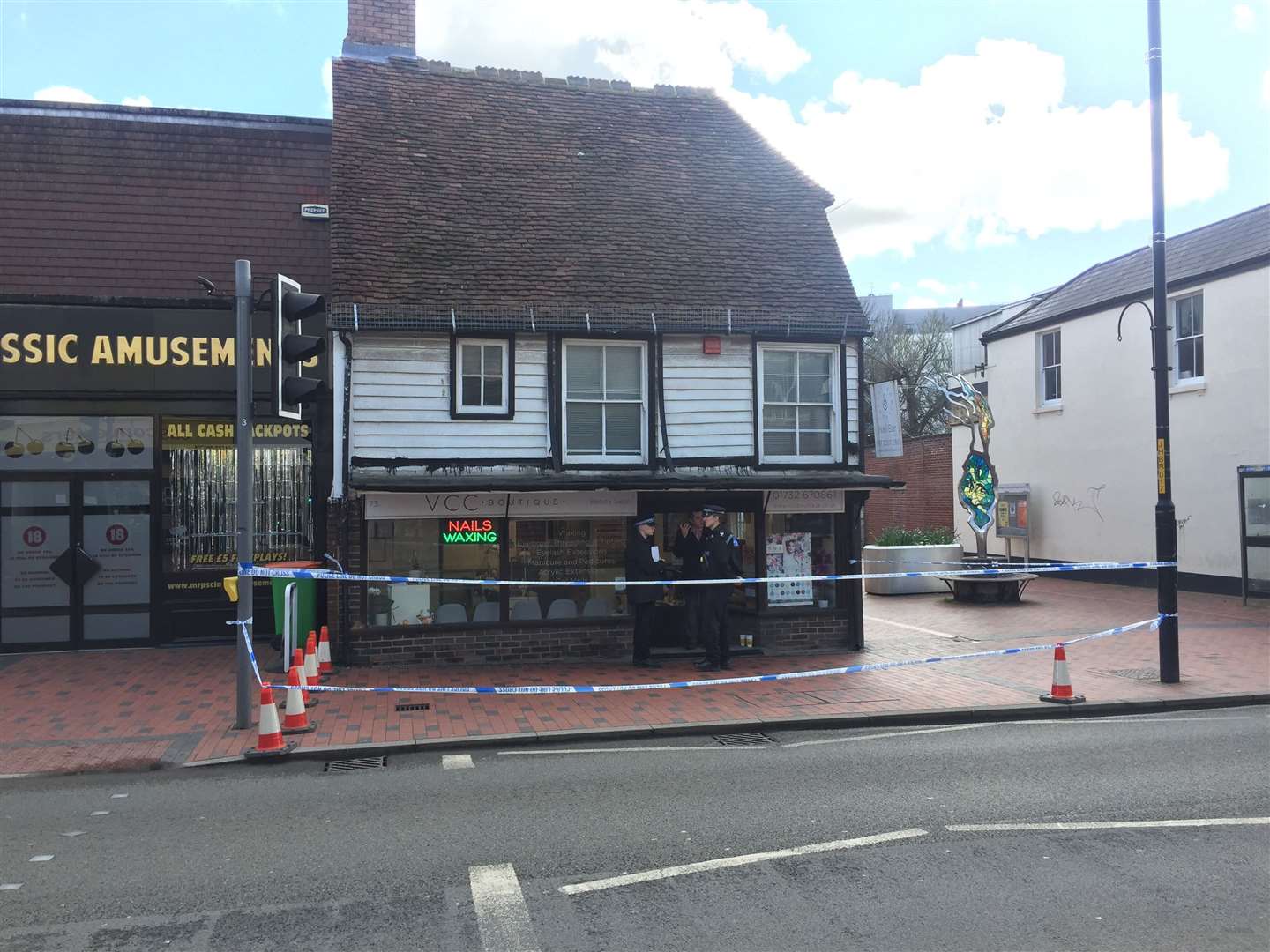 Police outside the nail bar in Tonbridge High Street