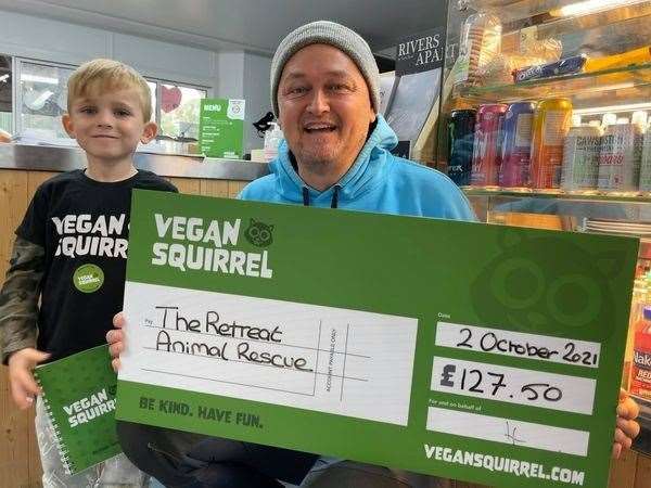 Harry Bidewell handing over the money he raised for The Retreat Animal Rescue, near Ashford