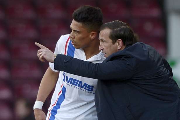 Gills boss Justin Edinburgh gives instructions to Bradley Garmston against Scunthorpe last Saturday