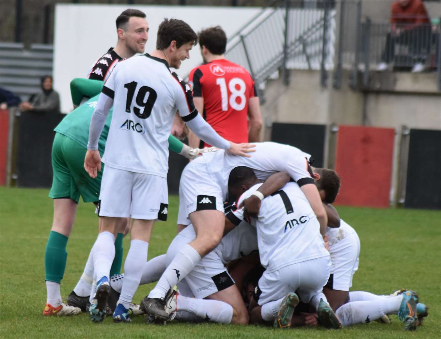 Faversham players celebrate Jake McIntyre's 90th-minute winner at Erith Town. Picture: Alan Coomes