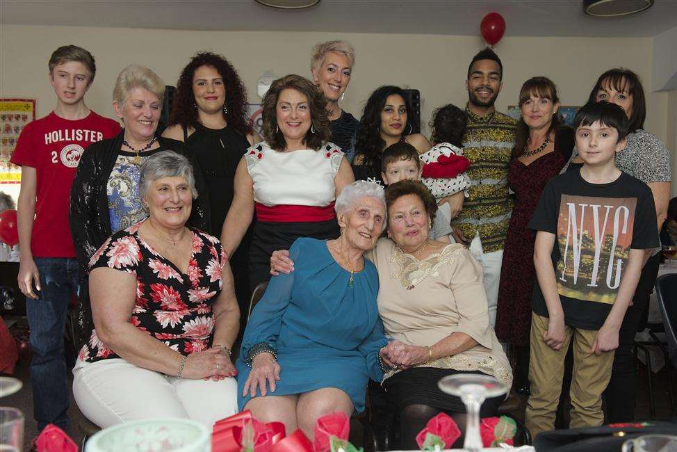 Mary, in blue, with five generations of her family.