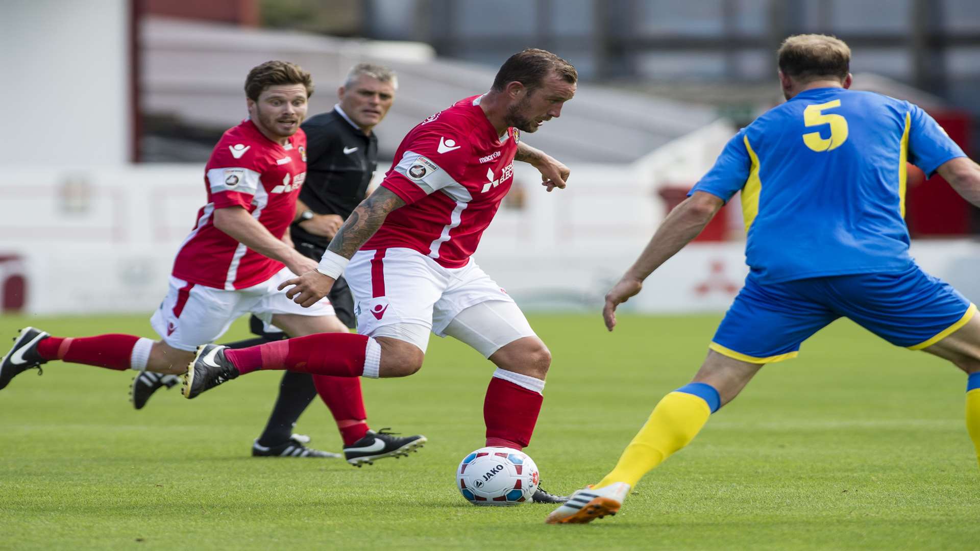 Danny Kedwell plays the ball past Jay Gasson, watched by JP Kissock Picture: Andy Payton