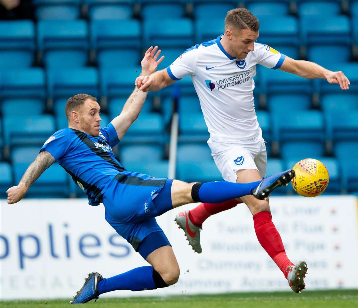 Gillingham's Barry Fuller challenges with Lee Brown. Picture: Ady Kerry