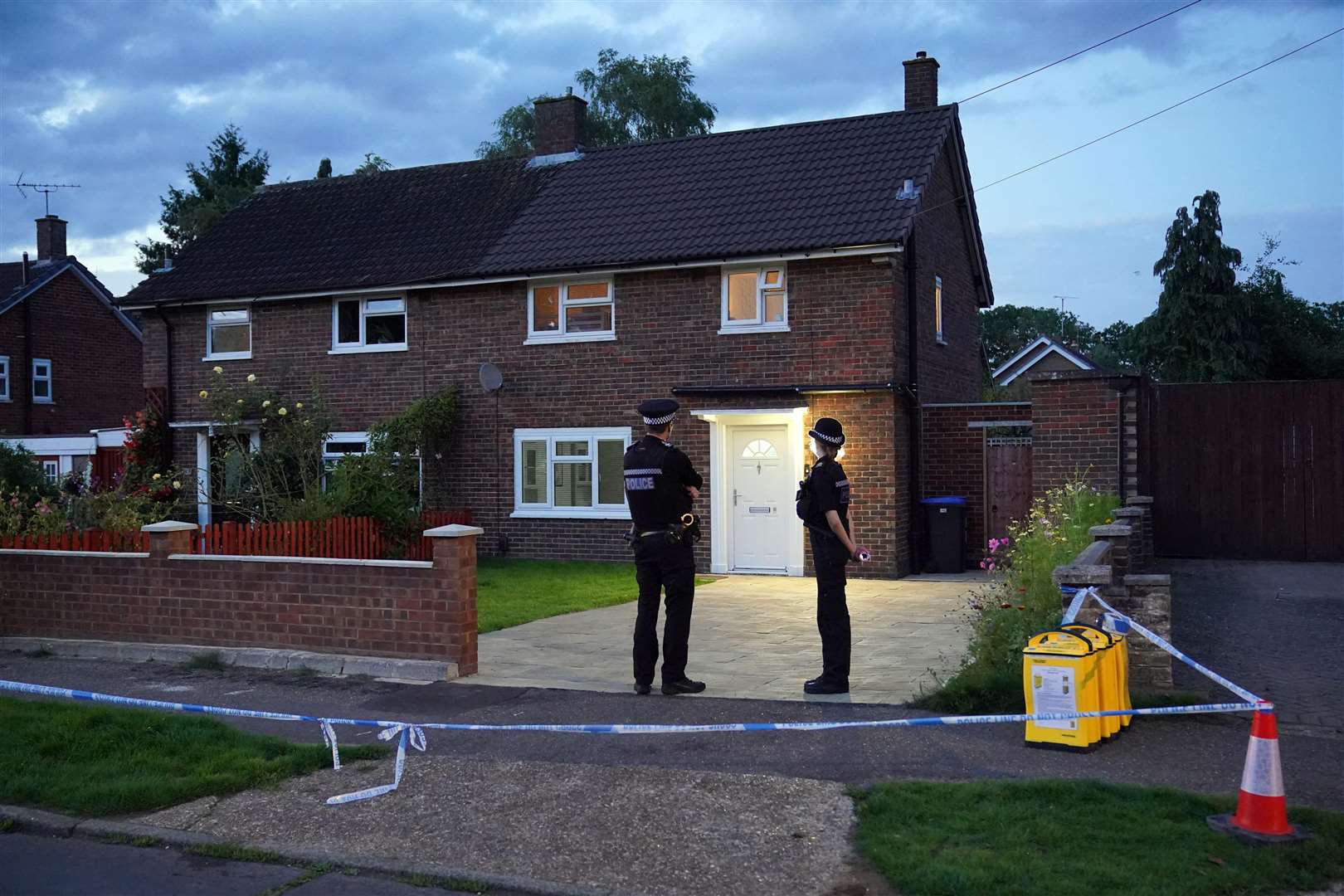 Police outside the family home in Woking, Surrey, where Sara Sharif, 10, was found dead (PA)