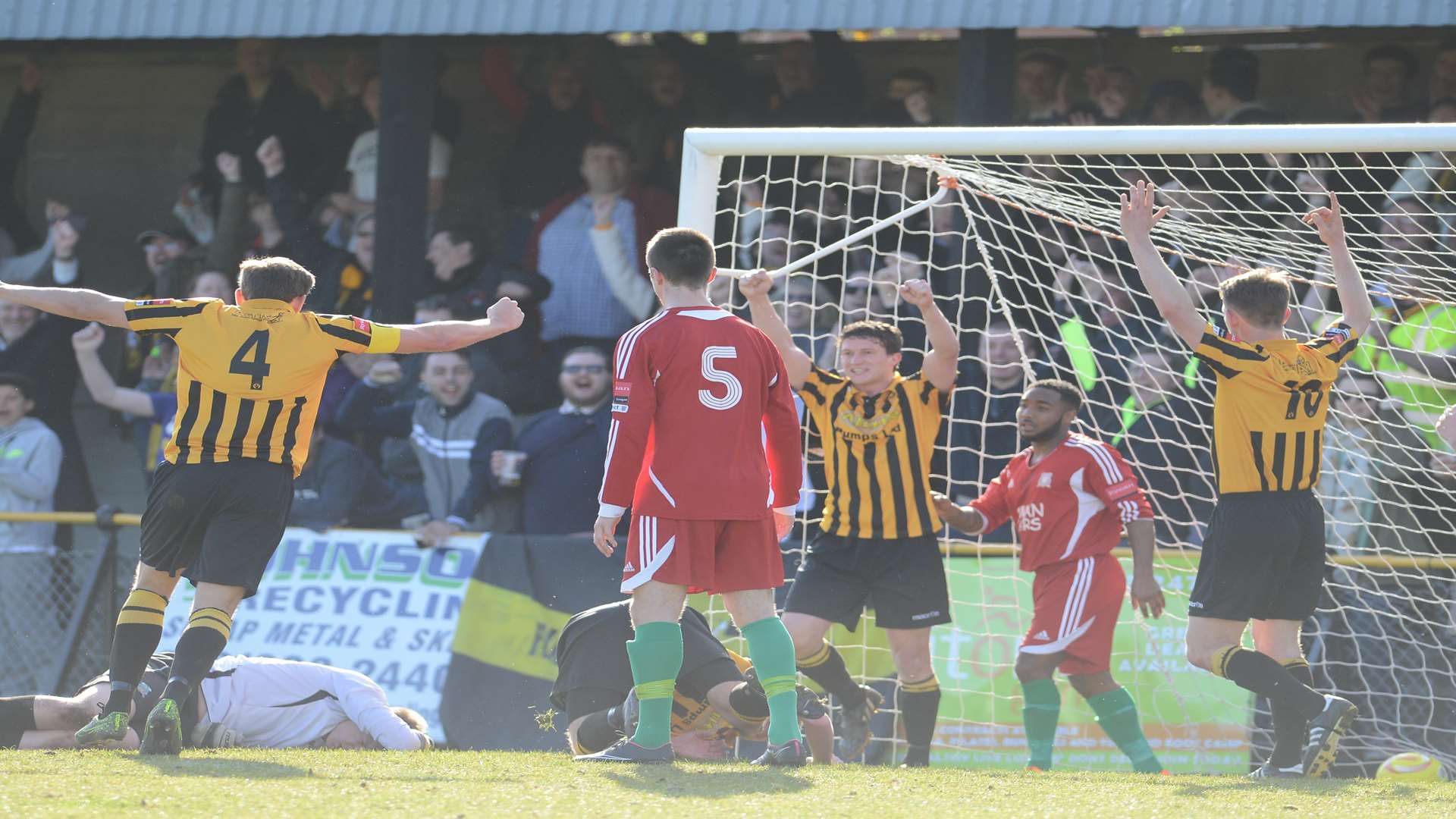 Frankie Chappell (centre) celebrates his opening goal as Folkestone clinch the title Picture: Gary Browne