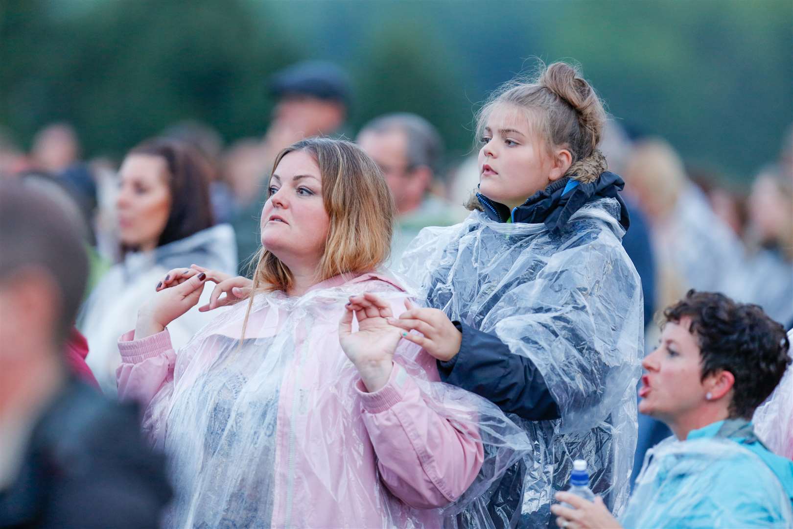 Dressed for rain, the crowd enjoy the show