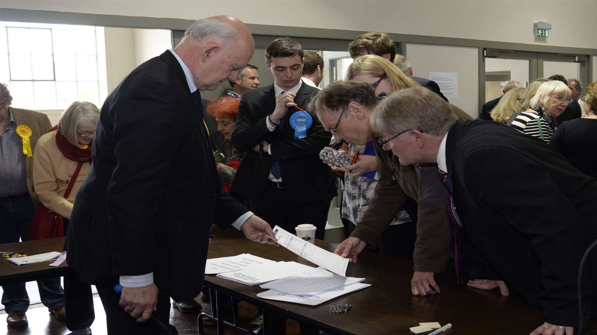 Agentsand candidates gather around returning officer Colin Carmichael