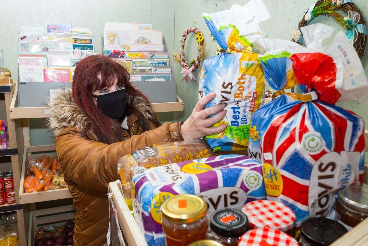 Volunteer Stevie Gates restocking the shelves. Picture: Martin Apps (45315562)