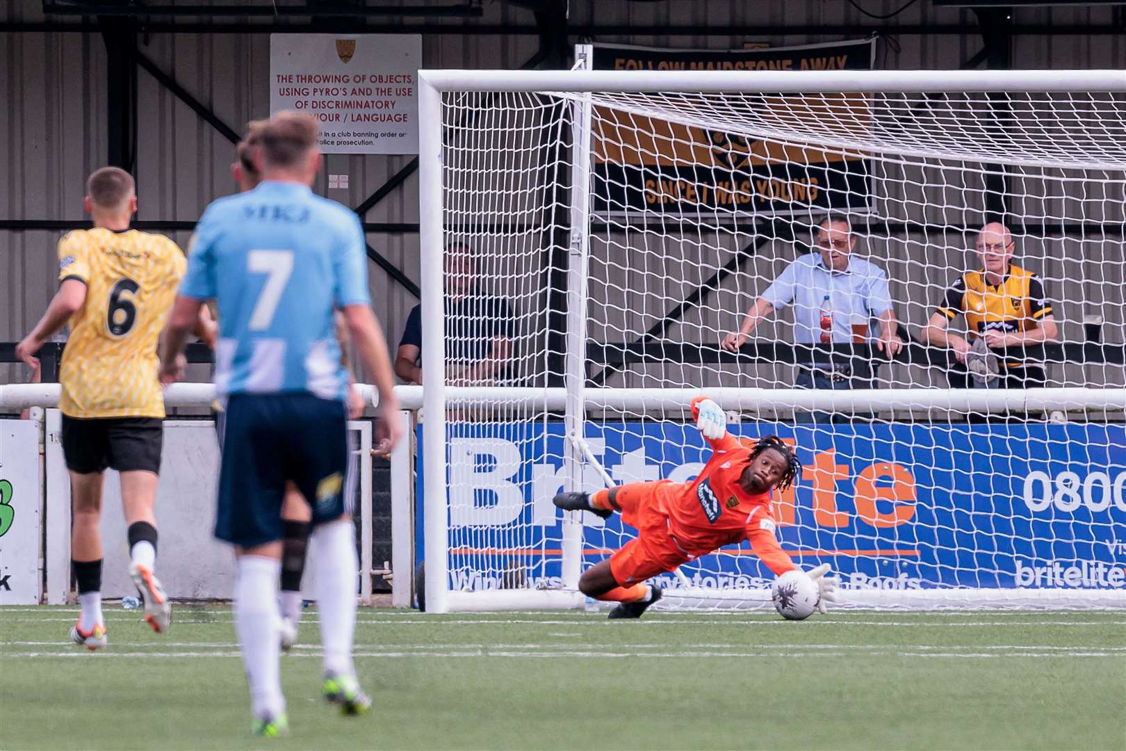 Alexis Andre Jr gets down to make a save during Maidstone's friendly win over Woking. Picture: Helen Cooper