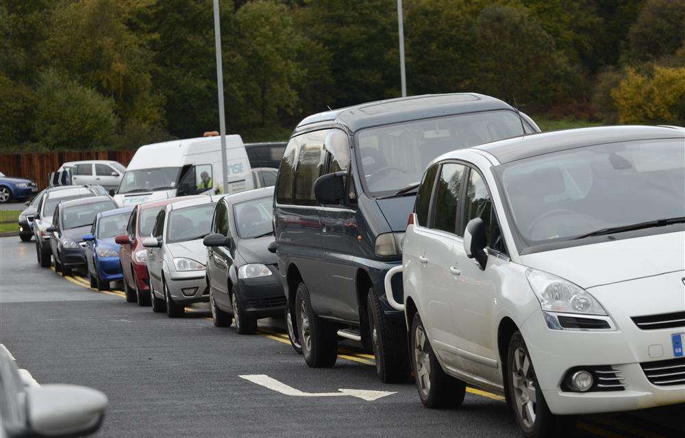 Cars parked along the entrance road John Lewis opening day