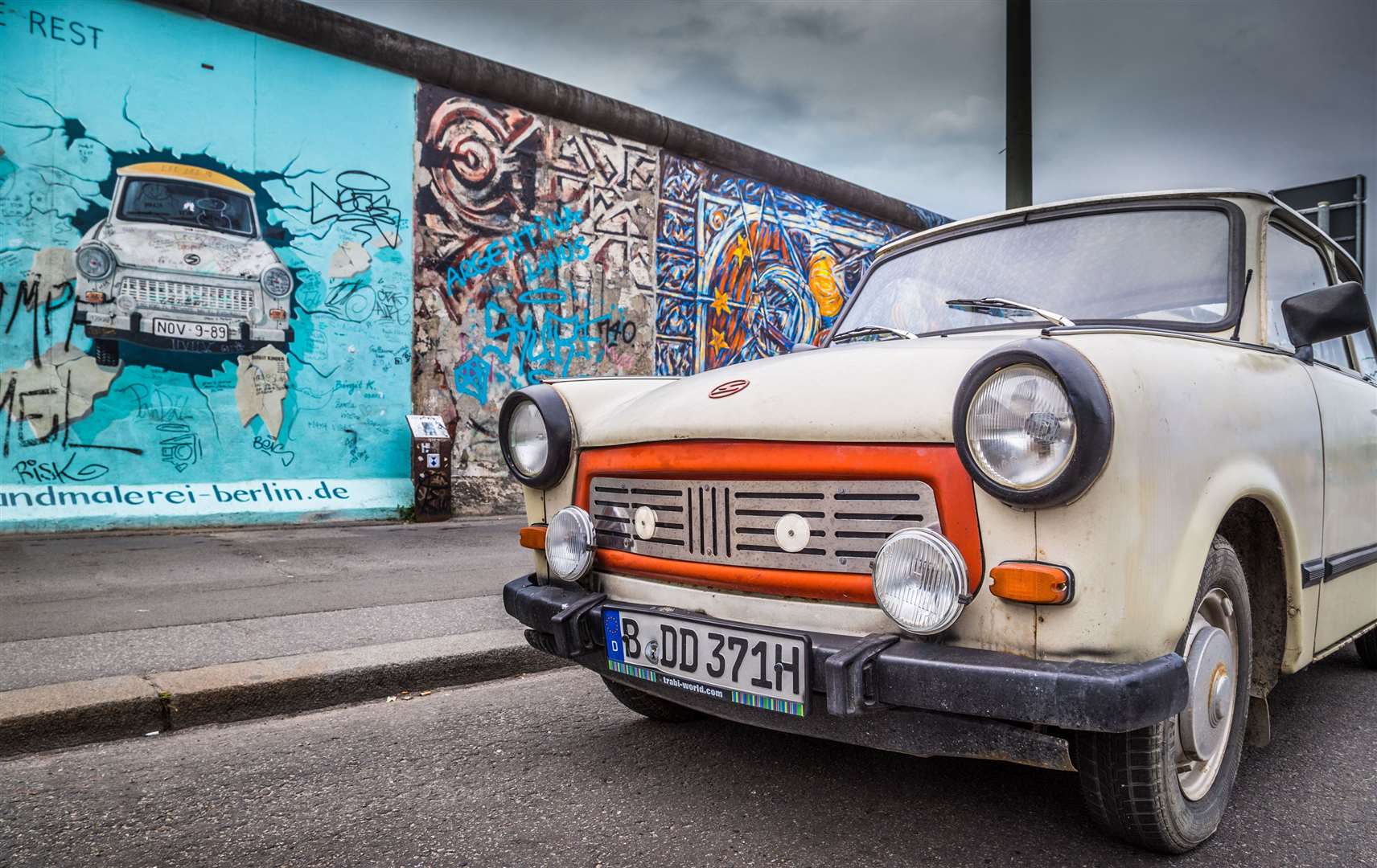 A Trabant car at the Berlin Wall