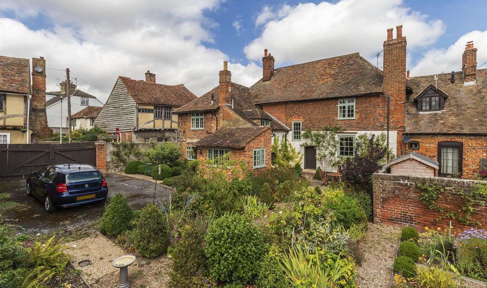 The garden is fairly large, considering its location, and there's space for two cars to park off-road. Picture: Saxon Shore