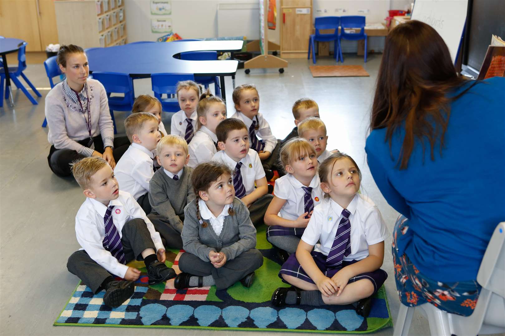 Ladybirds class hear a story from TA Laura Hunt.