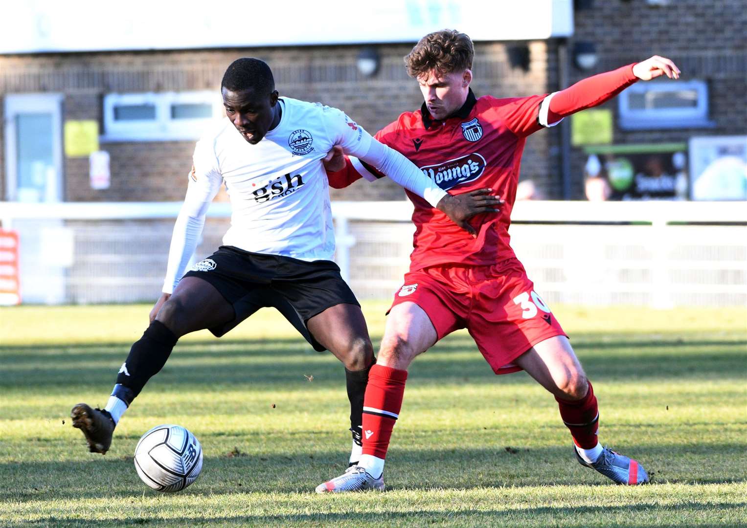 Dover's Michael Gyasi holds off Grimsby's Scott Burgess. Picture: Barry Goodwin (55133388)