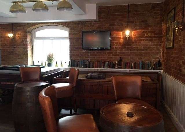 The back room, housing the mothballed pool table, also has a moderately-sized TV screen on the back wall