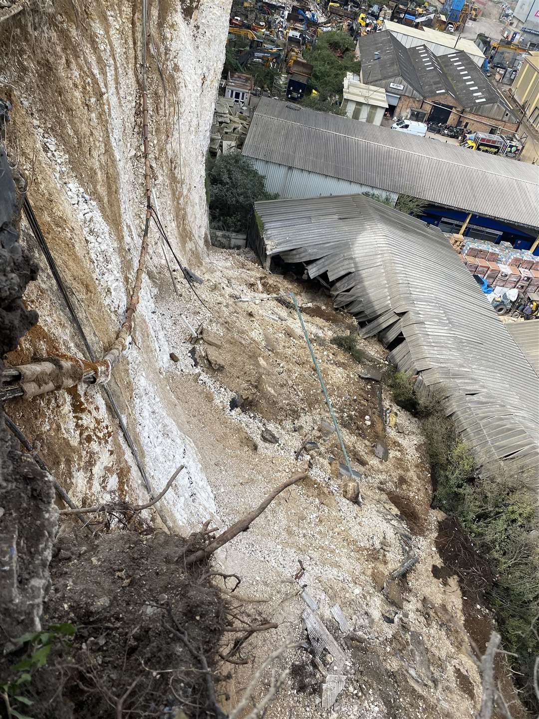 The view from the top of the collapsed cliff, showing how tons of rubble slid into Lancebox's property below