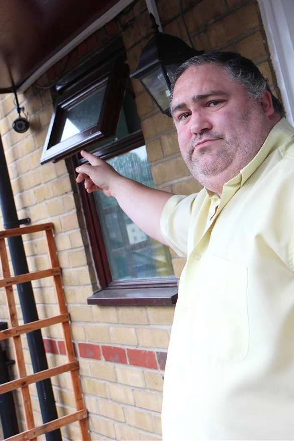 James Bugden shows one of the cameras at his home