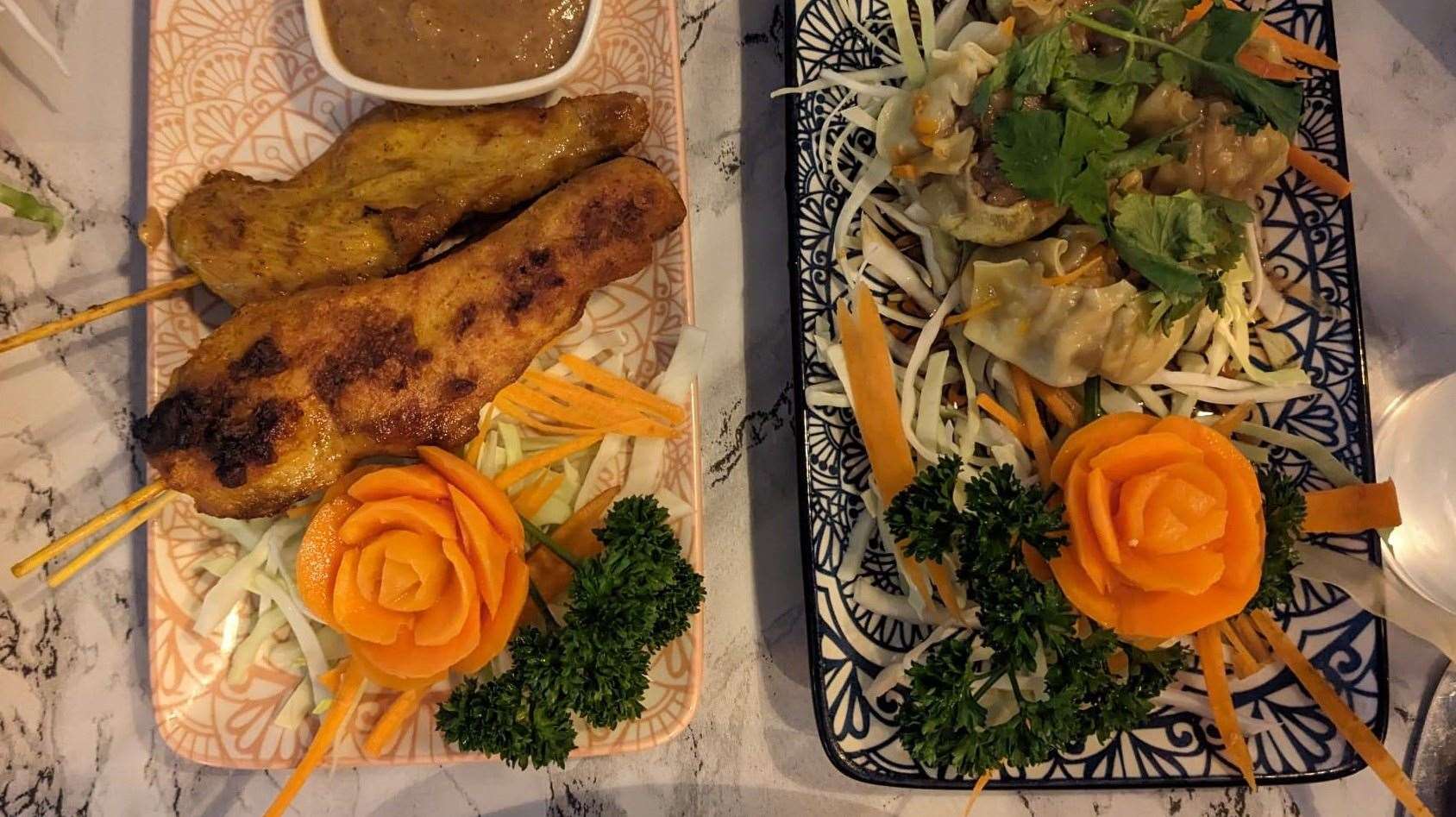 Starters of chicken satay and steamed dumplings