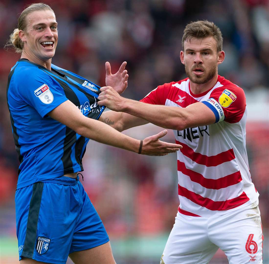 Andy Butler has a grip on Gills striker Tom Eaves. Picture: Ady Kerry