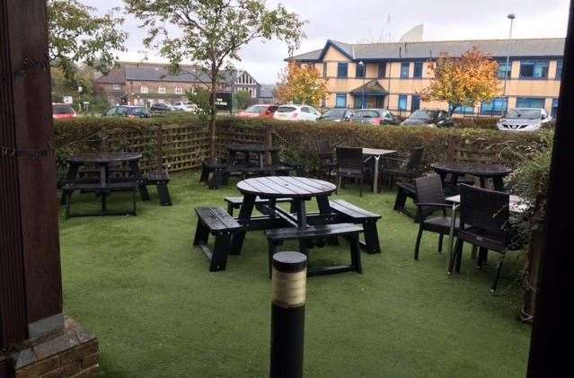 Artificial grass is much easier to maintain than the real stuff and in better weather I imagine a number of folk choose to sit out front