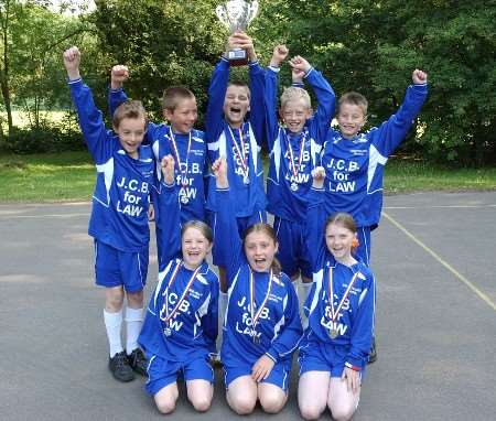 The triumphant side show off their hard-earned trophy. Picture: JIM RANTELL