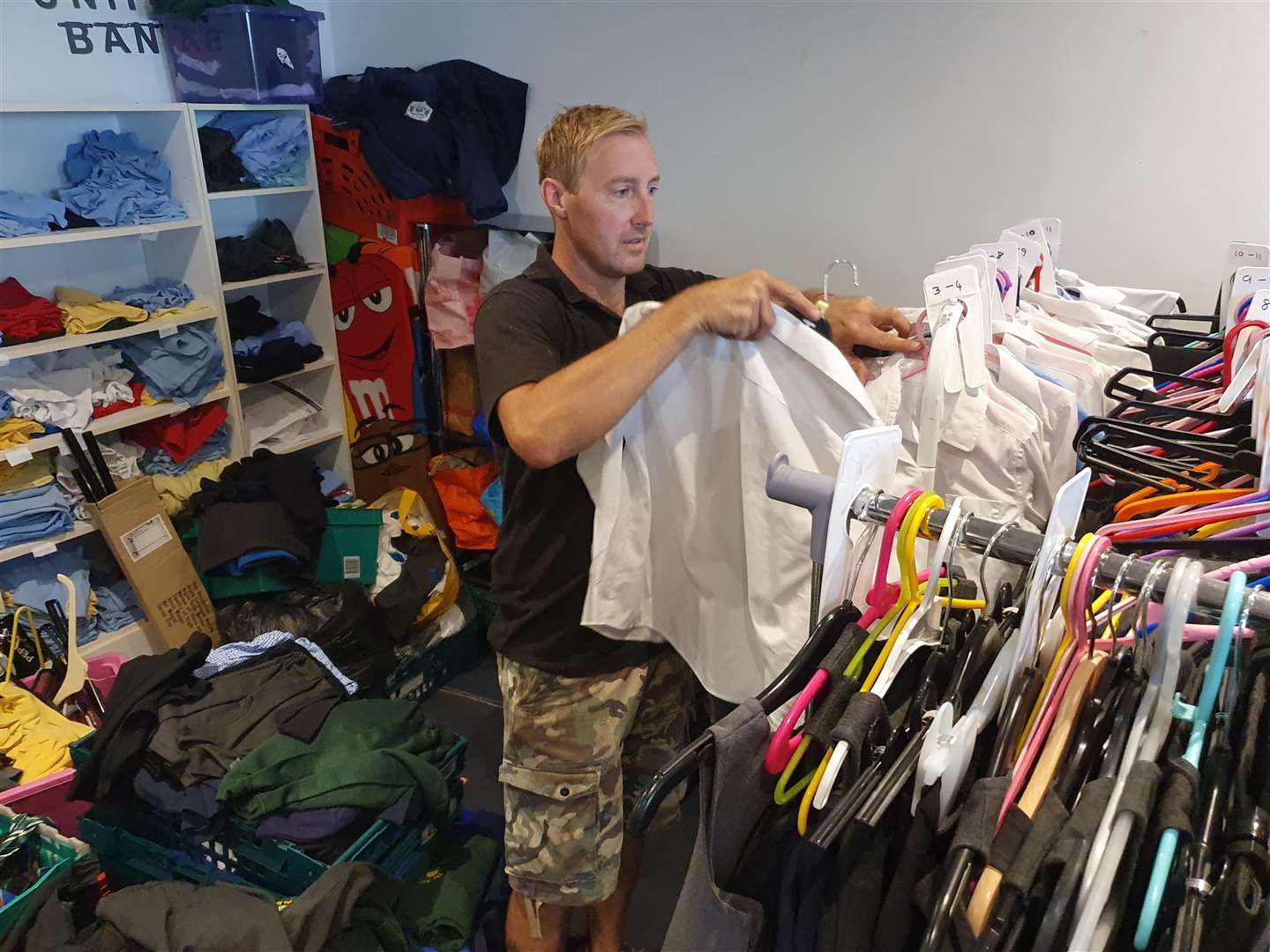 Steve Blakelock, operations manager, sifts through the rails at the Gillingham Street Angels clothes bank