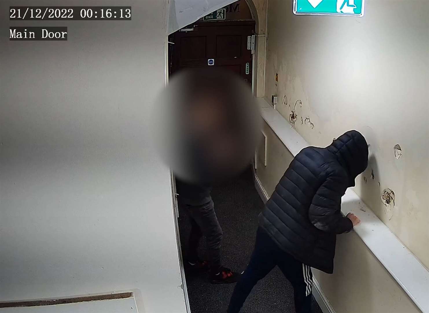 A youth headbutting a wall in the Metropole flats in Dover