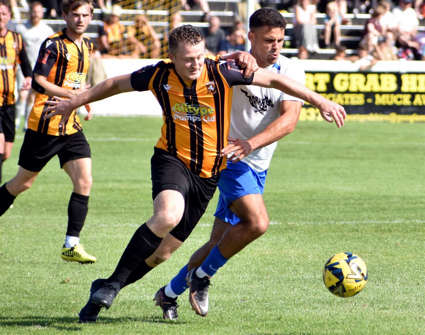 Folkestone defender Callum Davies tussles with Brad Schafer, of Hythe. Picture: Randolph File