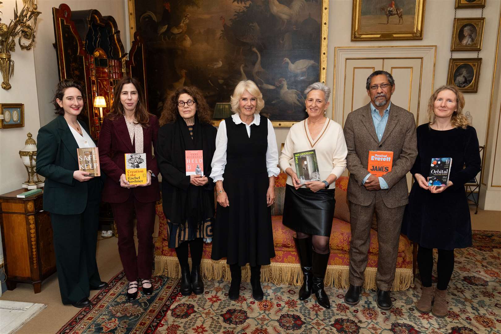 Left to right, Yael van der Wouden, Rachel Kushner, Anne Michaels, Queen Camilla, Charlotte Wood, Percival Everett and Samantha Harvey during a reception for the Booker Prize Foundation at Clarence House (Aaron Chown/PA)