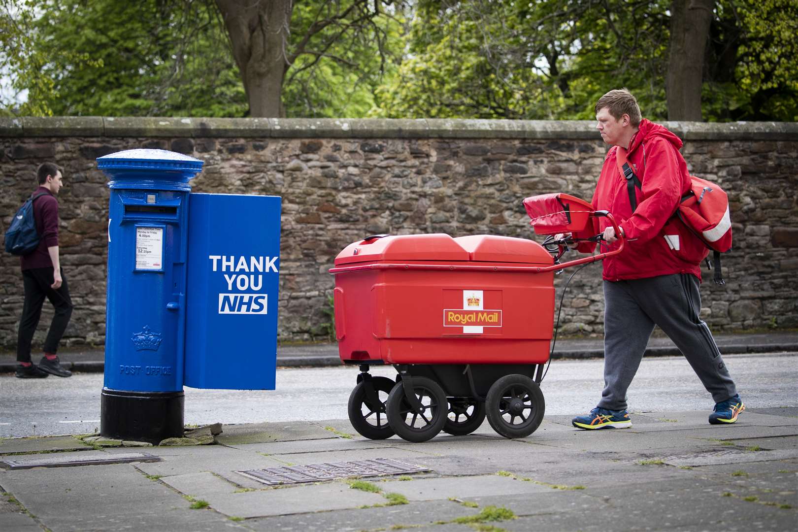 Postman Graeme Byers passes by one of the specially decorated postboxes in Edinburgh (Jane Barlow/PA)