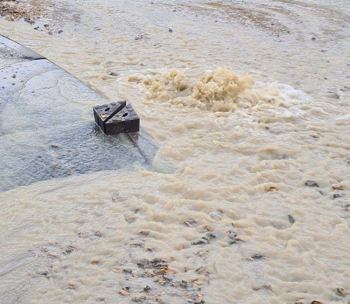 Water gushes from the road at the junction of Chestfield Road and Polo Way. Picture: Simon Roberts