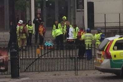 Medics treat the man in a stretcher after being pulled from the river